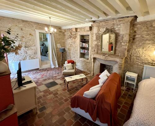a living room with a couch and a fireplace at Studio Bardin in La Charité-sur-Loire