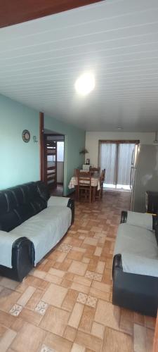 a living room with two beds and a table at Cabaña Dos Pinos in Durazno