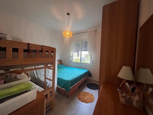 a small bedroom with a bunk bed and a window at Small Garden House in Draç