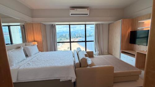 a bedroom with a bed and a large window at Tropical Executive Hotel 804 - Propriedade Particular in Manaus