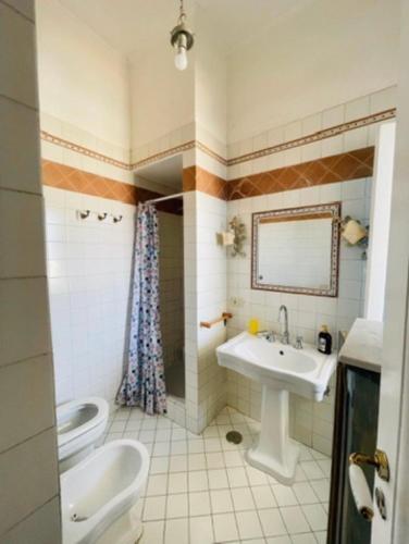 a bathroom with a sink and a toilet at Maison Artista in Procida