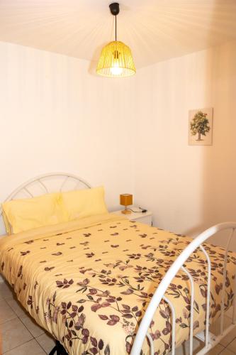 a bedroom with a bed and a lamp at Casa da Castanha Sernancelhe in Sernancelhe
