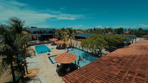 an overhead view of a swimming pool with an umbrella at Estância Costa do Sol in Nova Viçosa