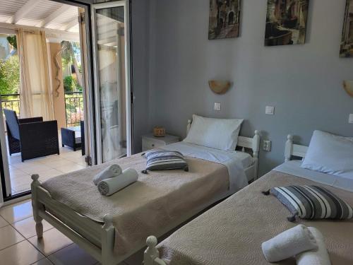 a bedroom with two beds with towels on them at Asprokavos beach apartment and studio in Kavos