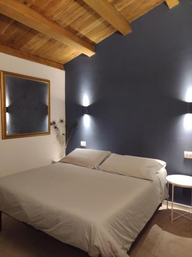 a bedroom with a bed and a blue wall at Casina Borgo Castello in Civitella di Romagna