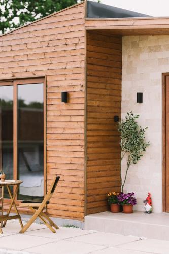 a wooden shed with a table and a chair at Casa Arte in Ulcinj