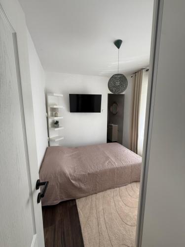 a bedroom with a bed and a flat screen tv at Villa Marea in Nin