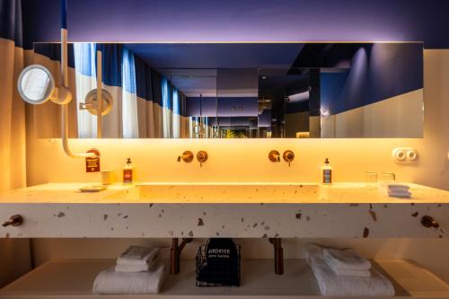a bathroom with a sink and a large mirror at Terreno Barrio Hotel in Palma de Mallorca