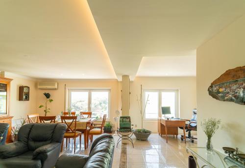 a living room with a couch and a table at Family Comfort House in Seixal
