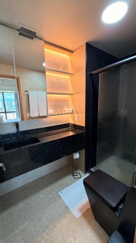 a bathroom with a black sink and a mirror at Tropical Executive Hotel 804 - Propriedade Particular in Manaus