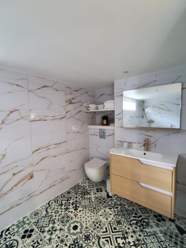 a bathroom with a sink and a toilet at Appartement - Cestas in Cestas