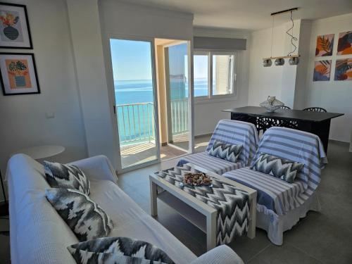 a living room with two couches and a table at Hawaii Beach Can Picafort in Can Picafort