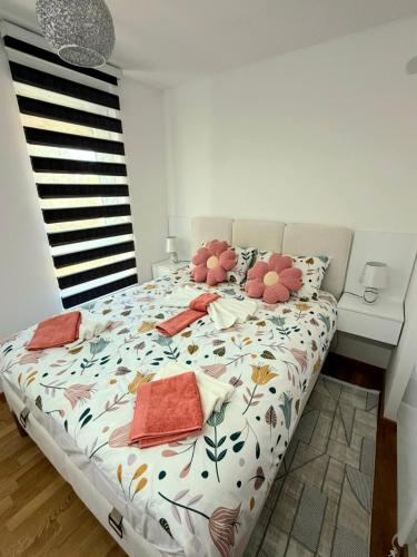 a bedroom with a large bed with flowers on it at Jefimija Apartman Sokobanja in Soko Banja
