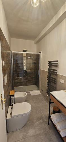 a bathroom with a tub and a toilet and a sink at HOUSE Sant'Angelo in Acquapendente