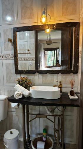 a bathroom with a sink and a toilet at Refúgio Aroma do Campo in Bagé