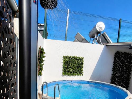 a swimming pool on the side of a building at Arrábida Cozy House in Palmela