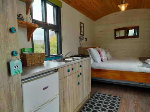 a kitchen with a sink and a bed in a room at Dingle Way Glamping Annascaul in Anascaul