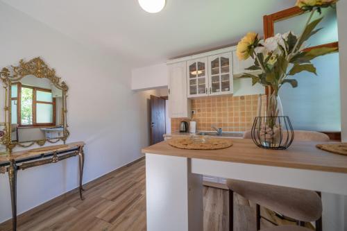 a kitchen with a counter with a vase of flowers at Apartments Nikčević in Kotor