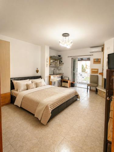 a bedroom with a large bed and a kitchen at Flogita 5 Seaside Apartments - 150m from Beach, Ideal for Families & Groups in Flogita