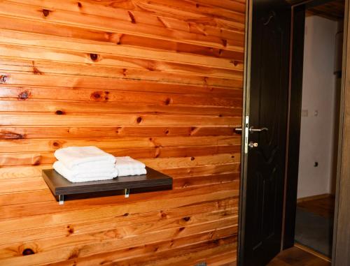 a room with a wooden wall with towels on a shelf at Modra Rijeka Resort in Glavatičevo
