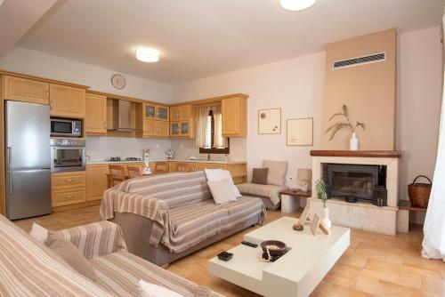 a living room with a bed and a kitchen at Sonias Point of View in Myrties