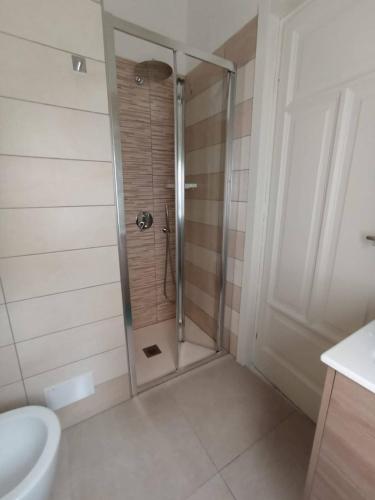 a bathroom with a shower with a toilet and a sink at Il Veliero in Bonassola