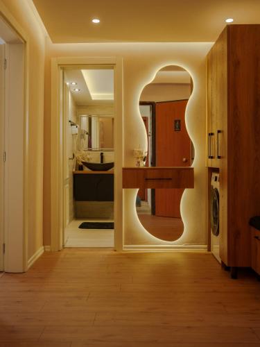 a kitchen with a large mirror in a room at Xhejn's Veranda 7 in Durrës