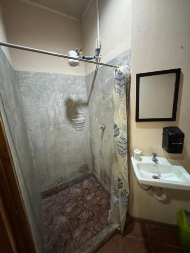 a bathroom with a shower and a sink at Aracari Stay in Quepos