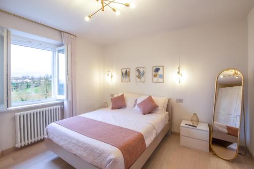a bedroom with a large bed and a mirror at Agriturismo Podere Sant' Agnese - Suite Apartment in Bibbiena