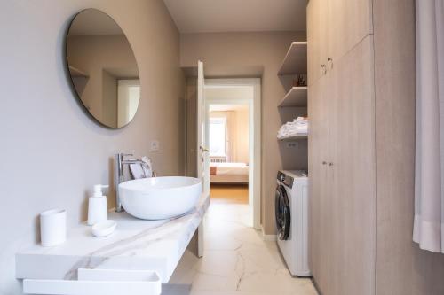 a bathroom with a white sink and a mirror at Agriturismo Podere Sant' Agnese - Suite Apartment in Bibbiena