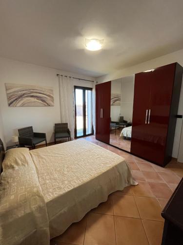 a bedroom with a large bed and a living room at Il Quinto senso di Lù in Capalbio
