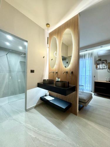a bathroom with a sink and a mirror at IONIAN SUITES by Bruskos in Agios Georgios