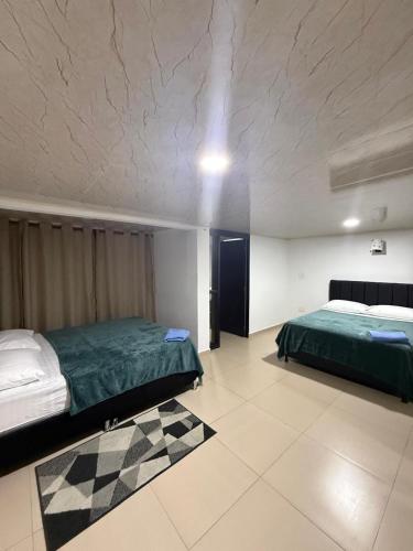 a bedroom with two beds in a room at Edificio La Roca in Pereira