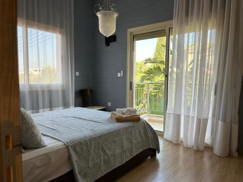 a bedroom with a bed and a large window at SeaView 6 Bedroom Villa & Private Pool in Limassol