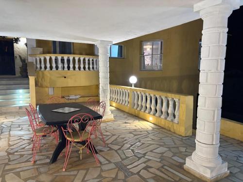 a patio with a table and chairs in a room at Villa Belle-Vue in Tabarka