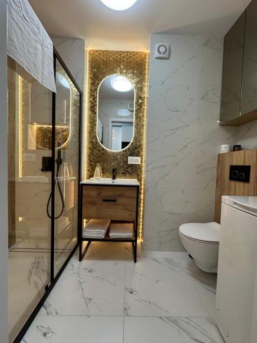 a bathroom with a sink and a mirror at LUXURY Portovo in Gdańsk