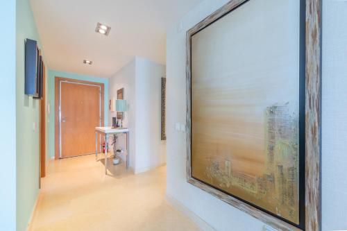a large painting on a wall in a hallway at Sesimbra Mar Apartamento in Sesimbra