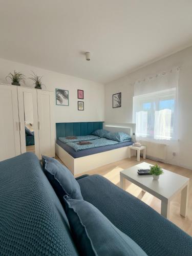 a living room with two beds and a table at Apartament z KLIMATYZACJĄ - ul Plebiscytowa 19 - darmowy parking in Opole