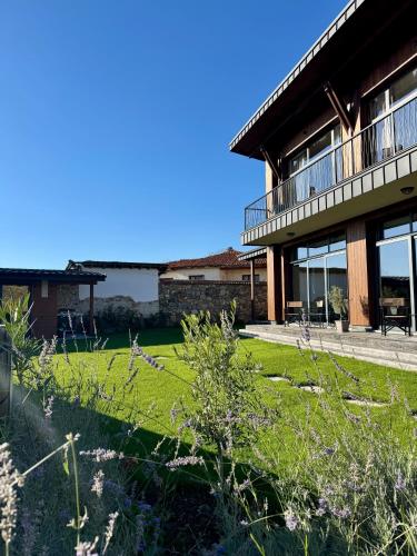 a house with a lawn in front of it at Veles Luxury House in Hisarya