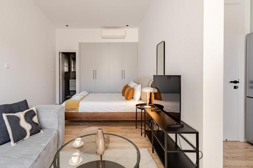 a living room with a bed and a couch at Yamas Urban Living Olympia Suites Old Town Studio in Limassol