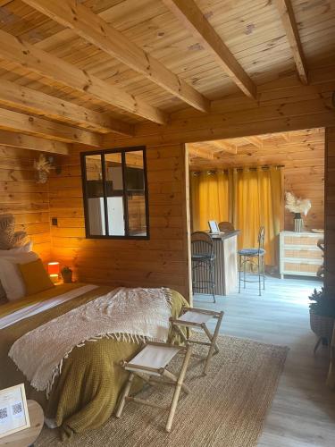 a bedroom with a bed in a wooden cabin at Chalet Le Luc - Casa Zenitude in Le Luc