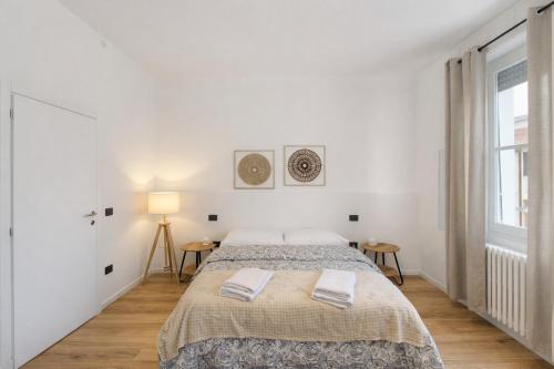 a white bedroom with a bed and a window at Affittacamere Villa Soria in Pesaro