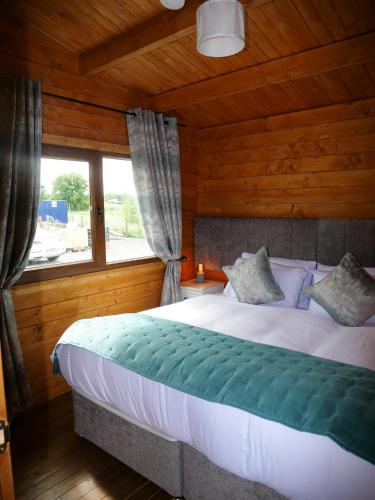 a bedroom with a large bed with a window at Alpaca My Bags! at Andean Alpacas in Mullingar