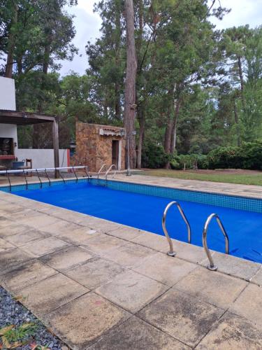 a swimming pool with metal railings around it at Kilua in Punta del Este