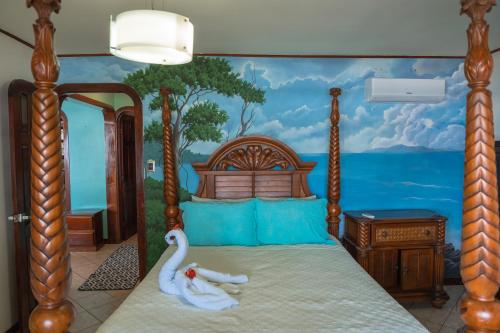 a bedroom with a bed with a swan on it at Host Company Jaco Luxury in Jacó