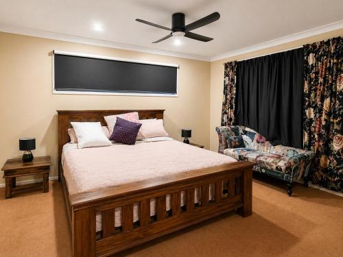 a bedroom with a bed and a ceiling fan at Hidden Gem in the CBD in Coffs Harbour