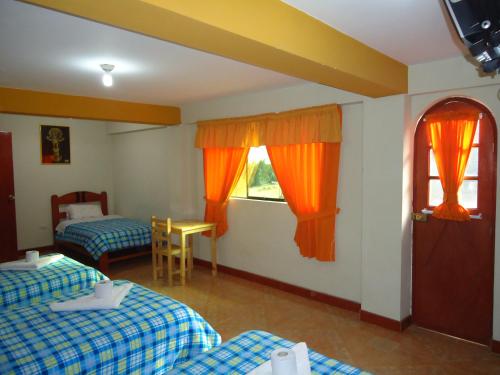 a hotel room with two beds and a window at Hotel Selena 1 in Huaraz