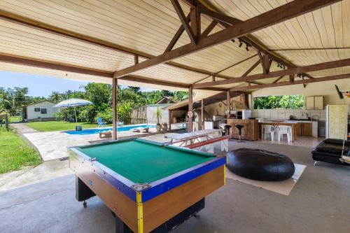 an outdoor entertaining area with a pool table at Chácara Caminho do Rio in Morretes