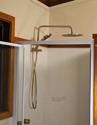 a shower in a bathroom with a glass door at 12 Apostles Cottages - Tullarook in Princetown