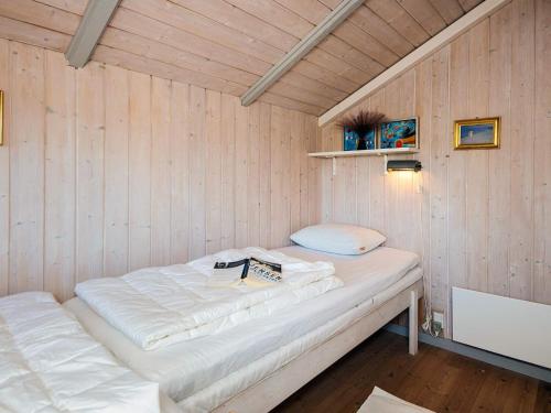 a room with a bed in a wooden wall at 8 person holiday home in Sydals in Neder Lysabild
